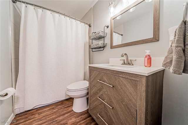 bathroom featuring a shower with curtain, vanity, toilet, and wood finished floors