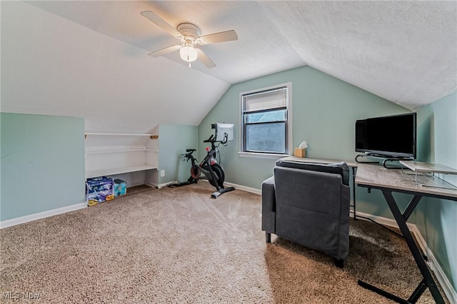 carpeted office space with vaulted ceiling, a textured ceiling, baseboards, and ceiling fan