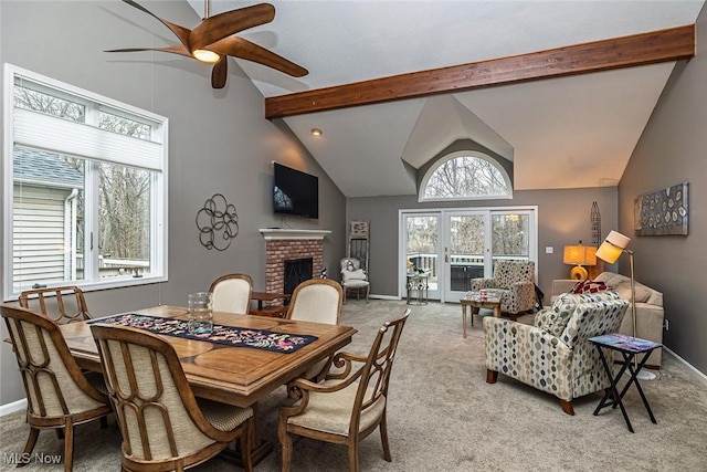 dining area featuring high vaulted ceiling, light carpet, baseboards, a brick fireplace, and beamed ceiling