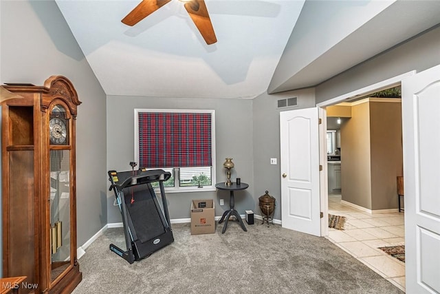 workout room featuring ceiling fan, carpet flooring, visible vents, baseboards, and vaulted ceiling