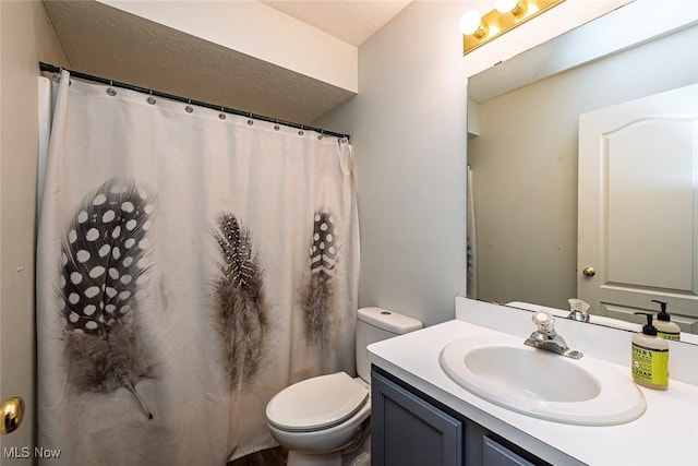 full bathroom featuring vanity and toilet