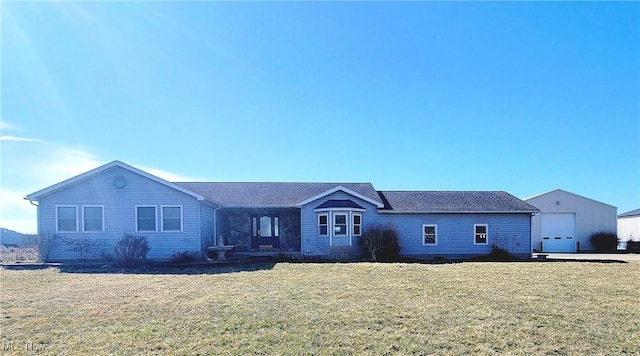 ranch-style house with a front lawn and an outbuilding