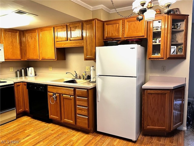 kitchen with white appliances, light wood finished floors, visible vents, brown cabinets, and a sink