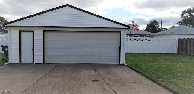 detached garage featuring fence