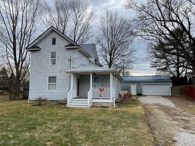 view of front of property featuring metal roof, an outbuilding, fence, a porch, and a front yard