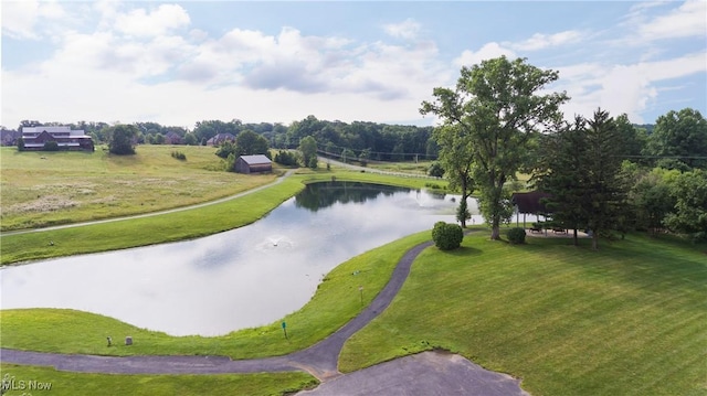 view of community with a water view and a lawn