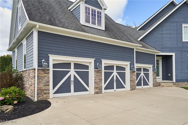 garage with concrete driveway