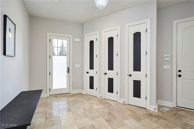 entryway featuring baseboards