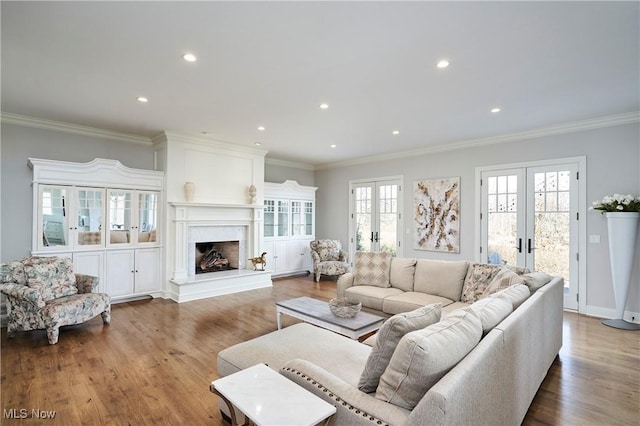 living room with ornamental molding, french doors, and wood finished floors