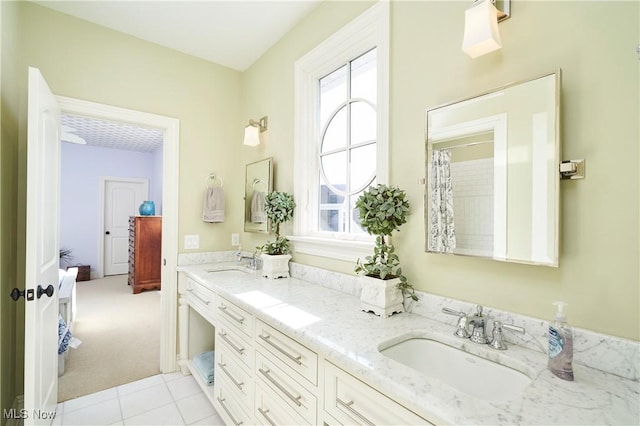 bathroom with double vanity, plenty of natural light, and a sink