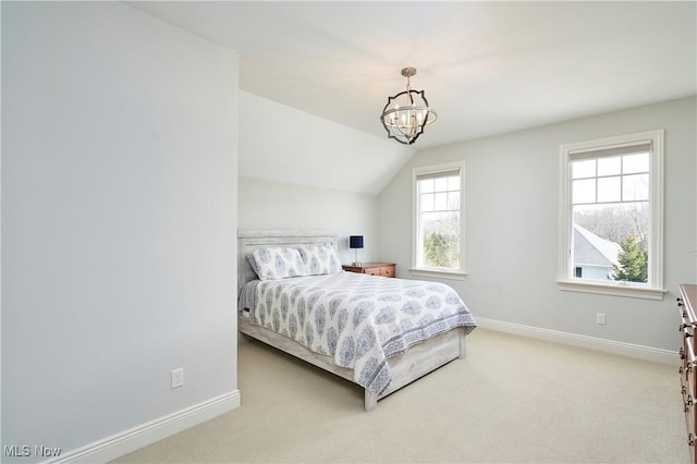 bedroom with carpet, a notable chandelier, lofted ceiling, and baseboards