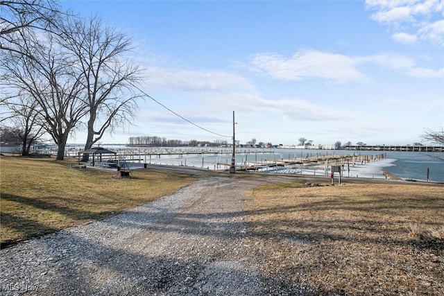 exterior space featuring a water view and a lawn