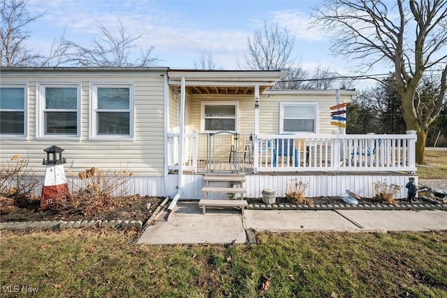 rear view of house featuring covered porch