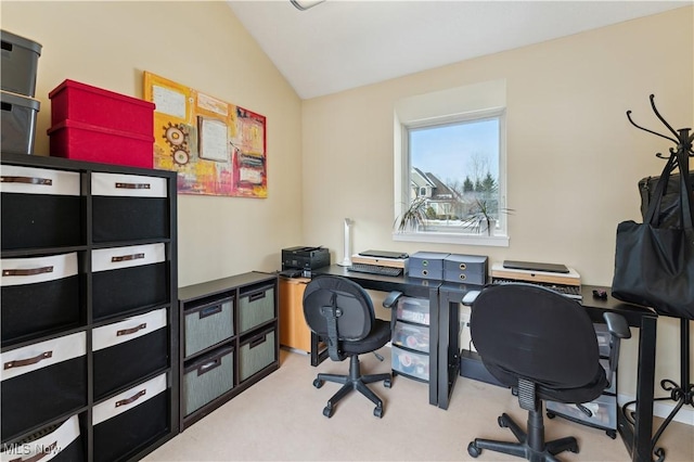 carpeted office space with vaulted ceiling