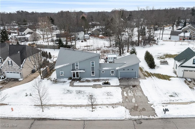 snowy aerial view with a residential view