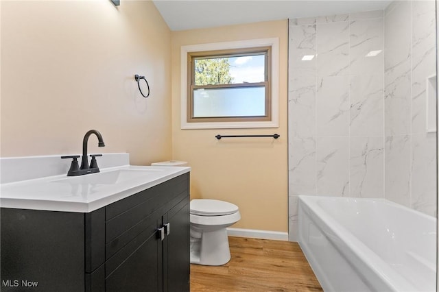 full bath featuring toilet, wood finished floors, vanity, and baseboards