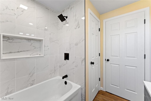 bathroom with shower / bathing tub combination and wood finished floors