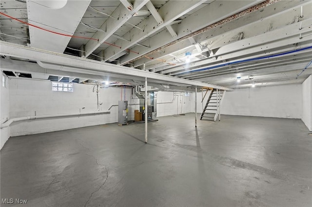 basement featuring heating unit and water heater