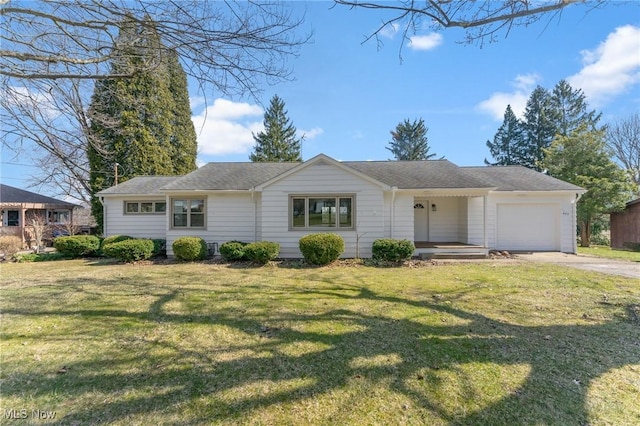 ranch-style house featuring driveway, a front yard, and an attached garage