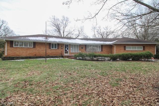 ranch-style home with a front lawn and brick siding