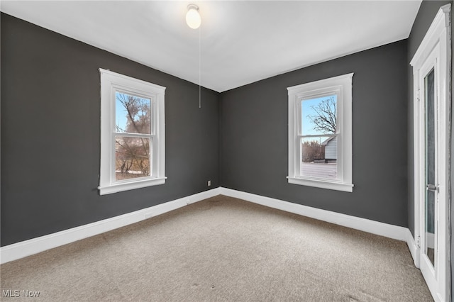 interior space featuring baseboards and a wealth of natural light