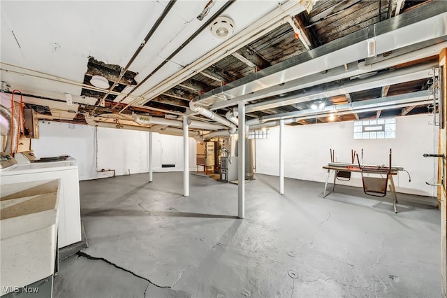 basement with washing machine and dryer and electric panel