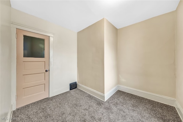 carpeted empty room featuring visible vents and baseboards