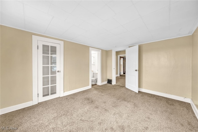 unfurnished room featuring carpet floors and baseboards