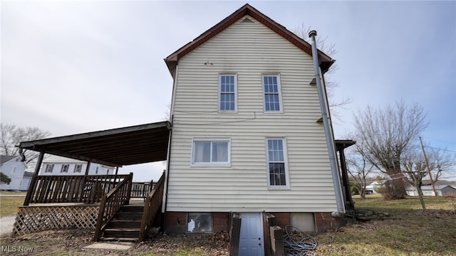 rear view of house featuring a deck