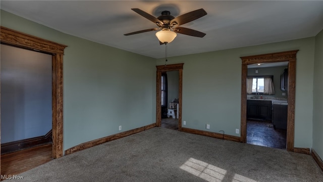 spare room with ceiling fan, baseboards, and carpet flooring