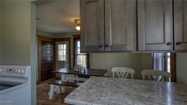 kitchen with washer / clothes dryer and wood finished floors