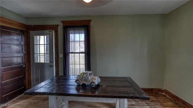 dining room featuring baseboards and dark wood finished floors