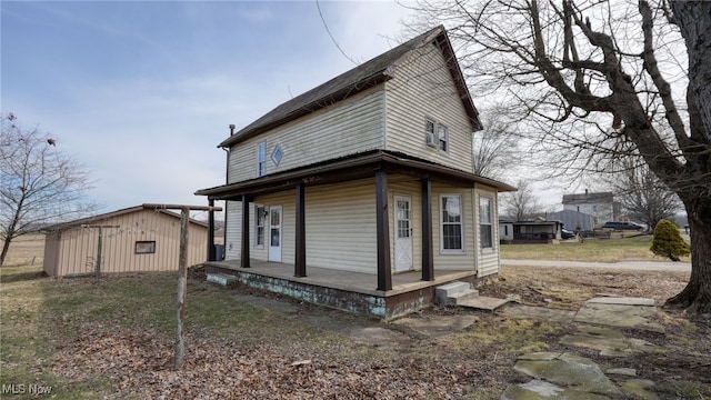 exterior space with covered porch and an outbuilding