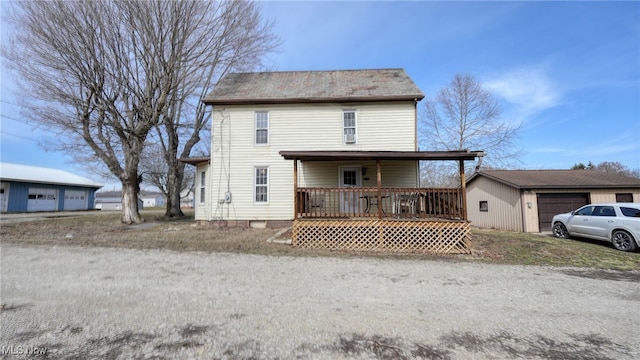 view of front of home with a garage and an outdoor structure