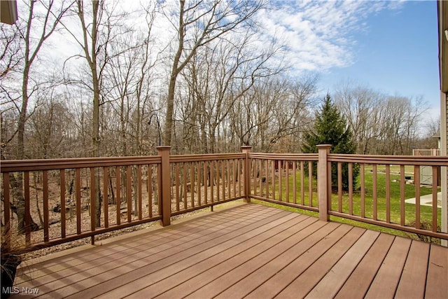 wooden terrace featuring a lawn