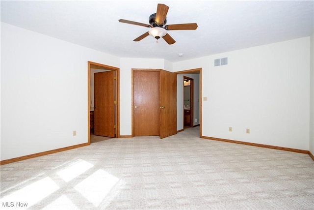 unfurnished bedroom with light colored carpet, visible vents, and baseboards