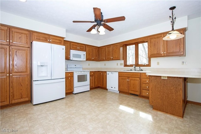 kitchen featuring light countertops, white appliances, and brown cabinets