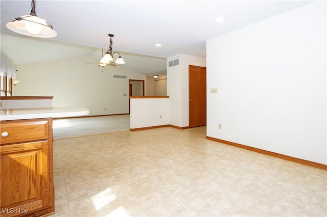 interior space with lofted ceiling, visible vents, baseboards, and a chandelier