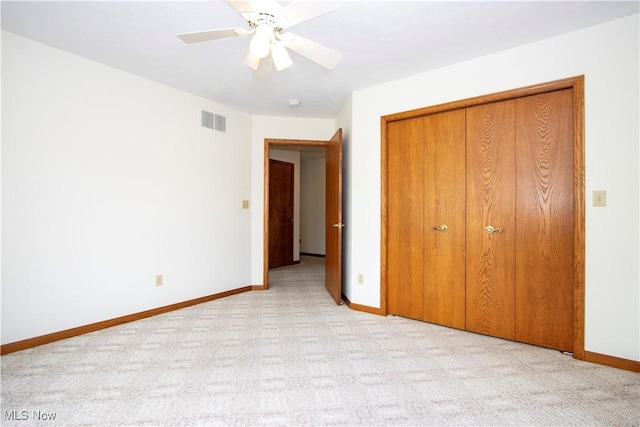 unfurnished bedroom featuring baseboards, a closet, visible vents, and carpet flooring