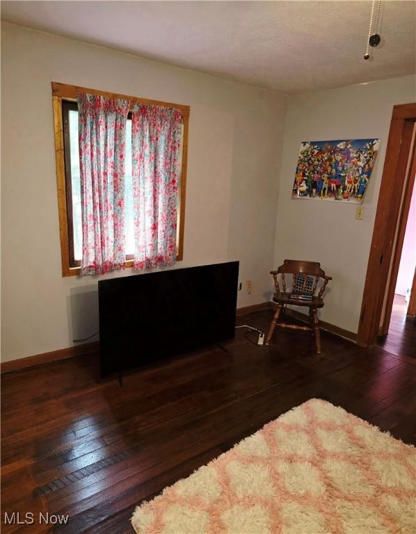 bedroom featuring baseboards and hardwood / wood-style flooring