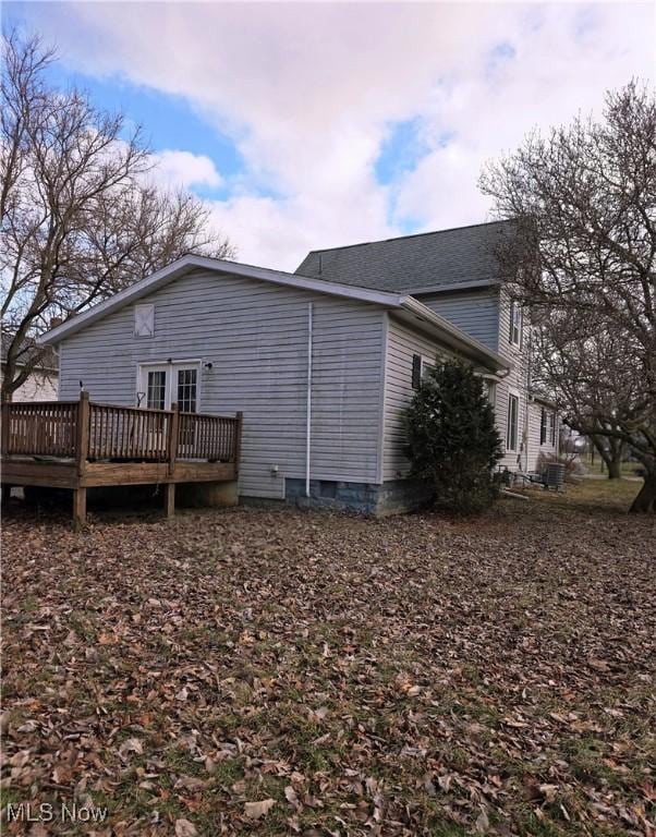 back of house with a deck and crawl space