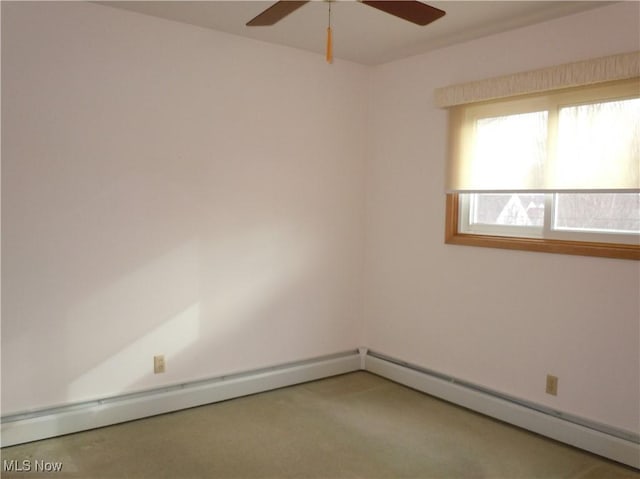 unfurnished room featuring a ceiling fan and baseboard heating