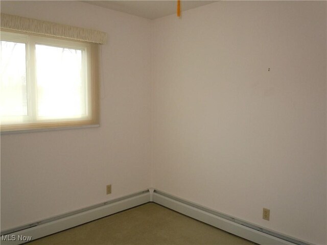 empty room with a baseboard heating unit