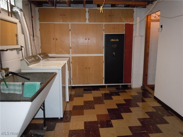 laundry area with laundry area, separate washer and dryer, and tile patterned floors