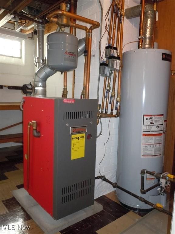 utility room with gas water heater and a heating unit