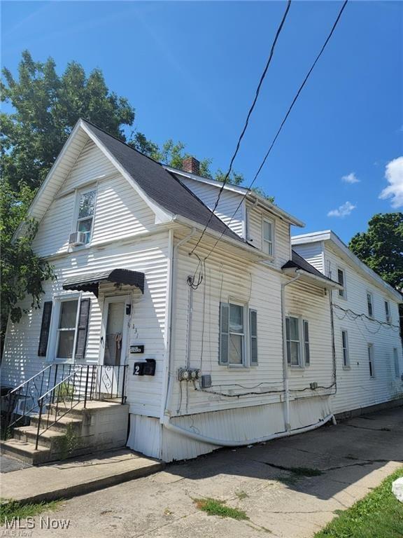 view of front of home featuring a chimney