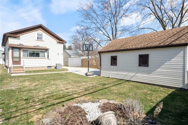 view of yard with entry steps, an outdoor structure, and fence