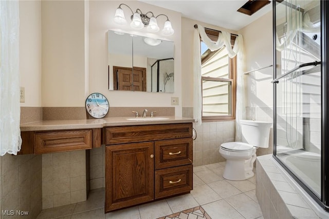 bathroom with toilet, tiled tub, a shower with door, and tile patterned floors