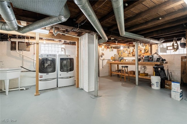 below grade area featuring independent washer and dryer, a sink, and a workshop area