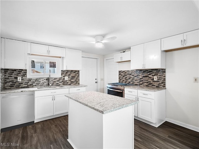 kitchen with stainless steel range with gas cooktop, dark wood finished floors, a sink, and dishwashing machine